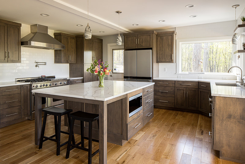 "Custom wood Amish kitchen cabinetry with soft-close hinges."